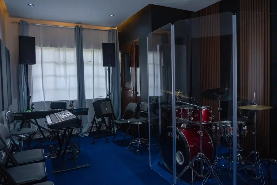 Santoori rehearsal room with drum kit, keyboards and acoustic screens